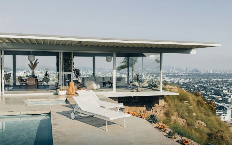 Full exterior view of Stahl House perched on Hollywood Hills with city skyline