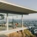Stahl House interior with floor-to-ceiling glass walls overlooking Los Angeles skyline