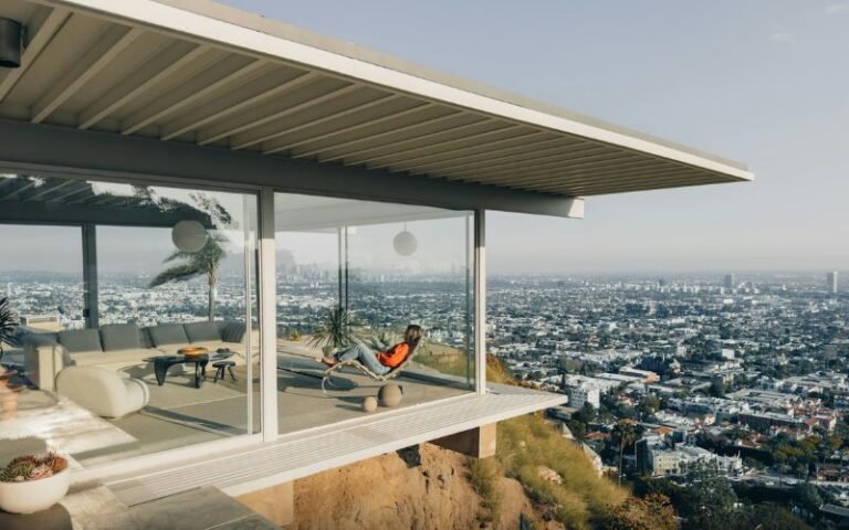 Stahl House interior with floor-to-ceiling glass walls overlooking Los Angeles skyline