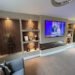 modern media wall unit with built-in shelves and wall mounted TV