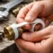 pipe thread sealant application on metal pipe with PTFE tape