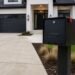 modern locking mailbox installed on post outside home