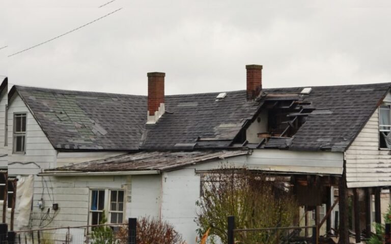 House damaged by natural disaster with broken roof and structural damage