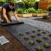 Ground cover plastic sheet installed in an outdoor landscaping setup