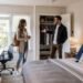 Young renter inspecting a furnished room before signing a rental agreement