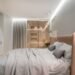 Modern comfortable bedroom interior with soft lighting and cozy bedding