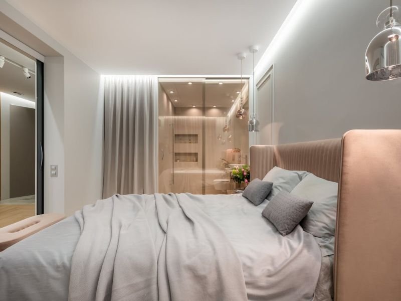 Modern comfortable bedroom interior with soft lighting and cozy bedding
