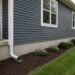 Suburban home foundation with visible cracks and drainage protection