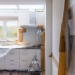 Partially renovated kitchen with cabinets covered in protective plastic during a remodeling project