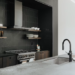 Modern kitchen with a light gray countertop, dark cabinets, and minimalist design elements showcasing a cohesive kitchen style