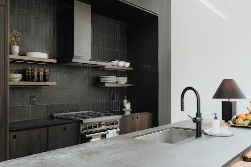 Modern kitchen with a light gray countertop, dark cabinets, and minimalist design elements showcasing a cohesive kitchen style