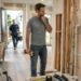 Homeowner deciding whether to DIY or call a professional for home repairs