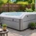 Luxury Whisper Spas Harmony hot tub with infinity-edge waterfall on a modern backyard patio