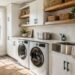 Modern utility room with white cabinets, countertop over washer and dryer, utility sink, and organized storage