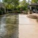 Driveway and patio showing the difference between dirty and professionally deep-cleaned hardscape
