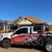 Professional roofing contractors inspecting and replacing a residential roof after storm damage