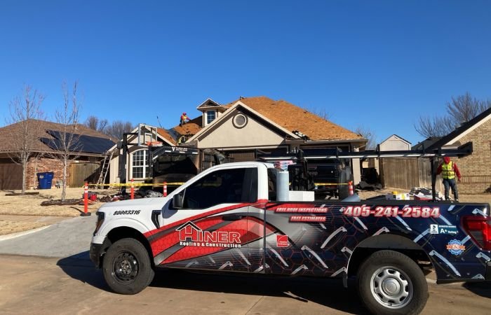 Professional roofing contractors inspecting and replacing a residential roof after storm damage