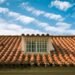 Terracotta tile roof on a well-maintained home showcasing long-term home improvement