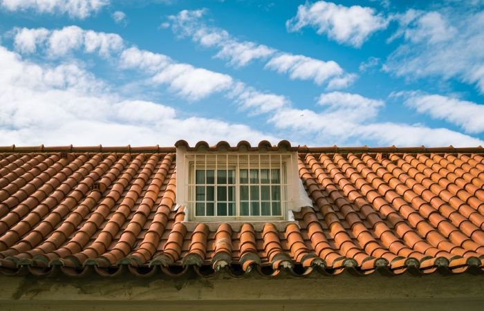 Terracotta tile roof on a well-maintained home showcasing long-term home improvement