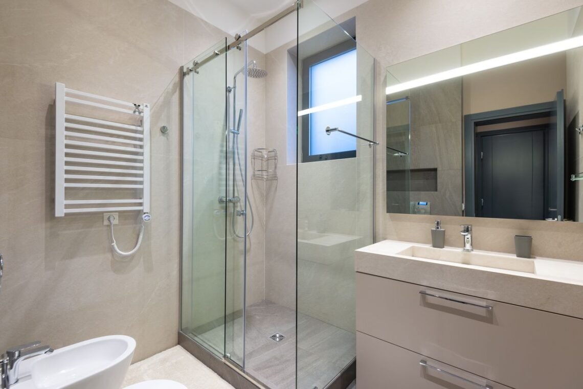 Modern walk-in shower with frameless glass enclosure and contemporary bathroom design