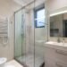 Modern walk-in shower with frameless glass enclosure and contemporary bathroom design