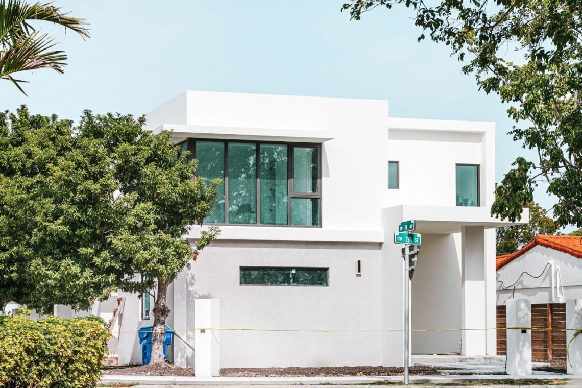 Modern white home with large impact-resistant windows