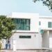 Modern white home with large impact-resistant windows