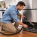 Atlanta homeowner cleaning refrigerator condenser coils
