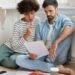 Couple reviewing rent payment documents in an apartment