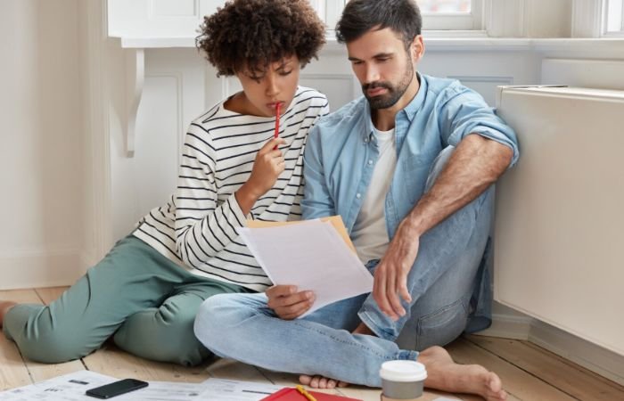Couple reviewing rent payment documents in an apartment